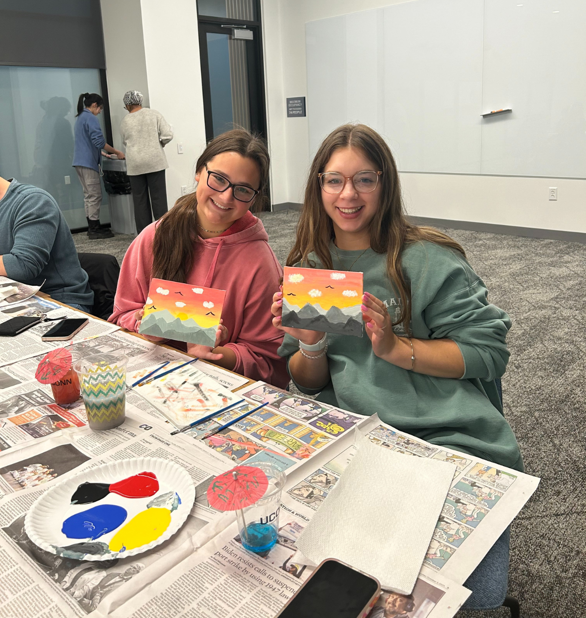 Two students holding up their painting