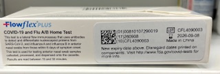 Side view of the Flowflex Plus COVID-19 and Flu A/B Home Test box showing product description, regulatory labeling, lot and expiration details, and disposal instructions.